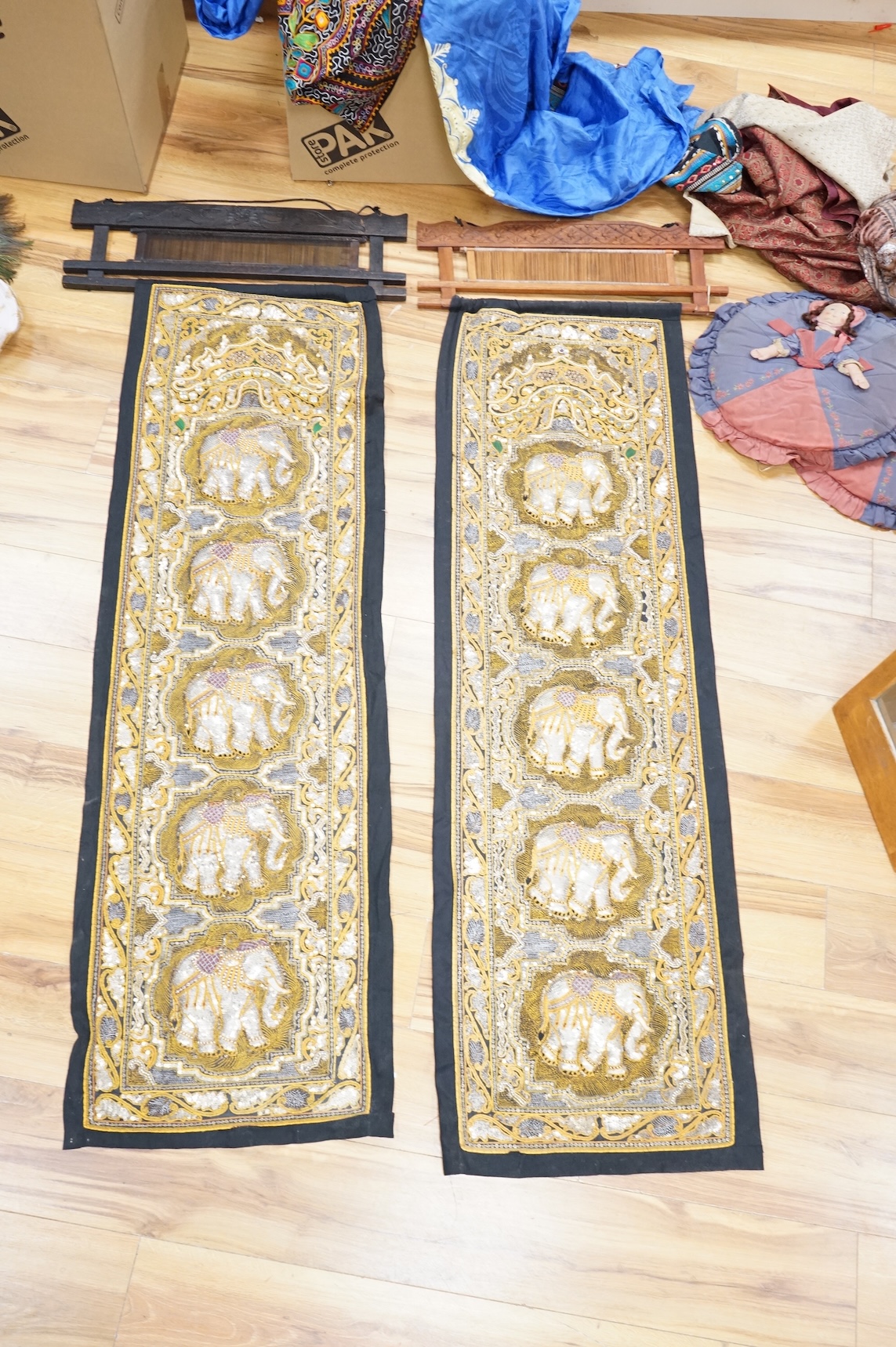 A quantity of mostly 20th century Middle Eastern and Indian woven and printed textiles and a peacock feather fan (2 boxes).